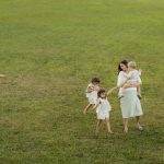 A joyful family enjoying a sunny day outdoors in a green park.