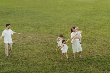 A joyful family enjoying a sunny day outdoors in a green park.