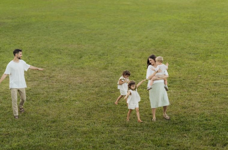 A joyful family enjoying a sunny day outdoors in a green park.
